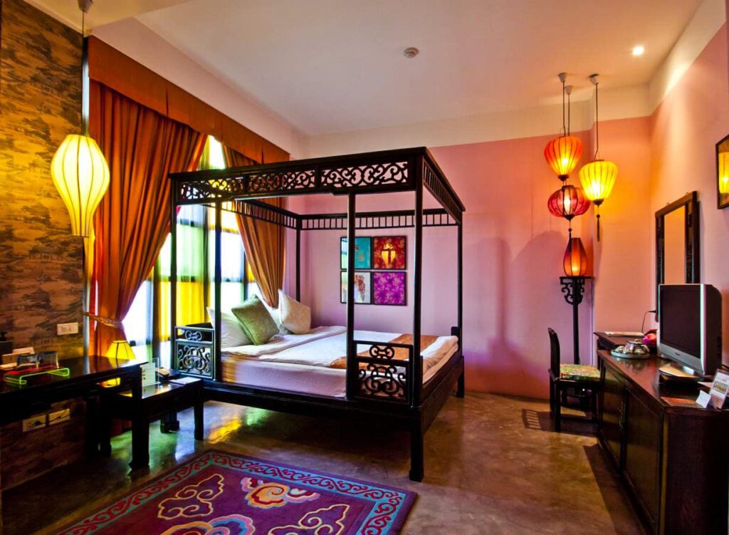 Colourful art deco hotel room at Shanghai Mansion Bangkok with vintage design