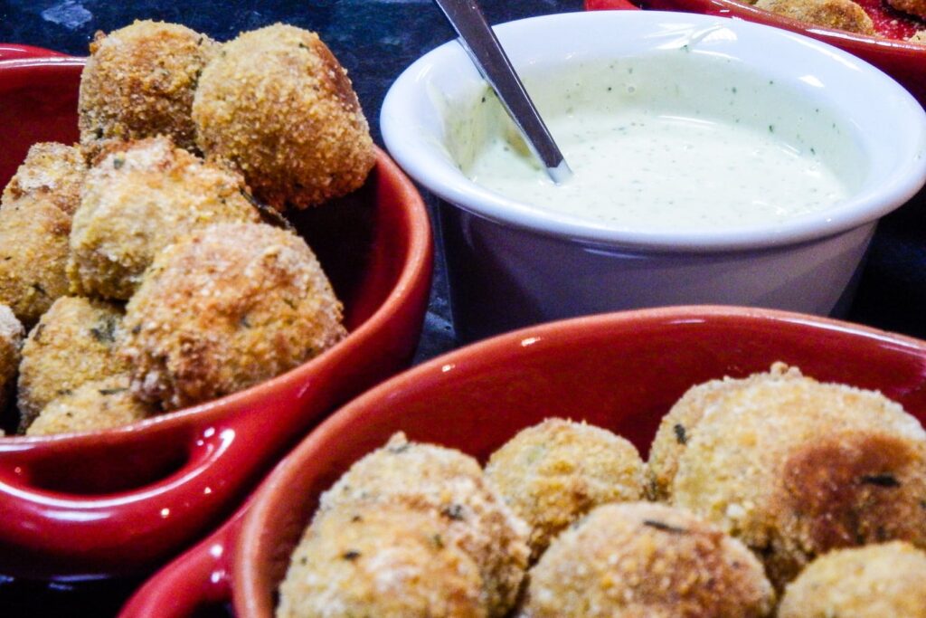 Golden fried Portuguese alheira meatballs served with aioli.