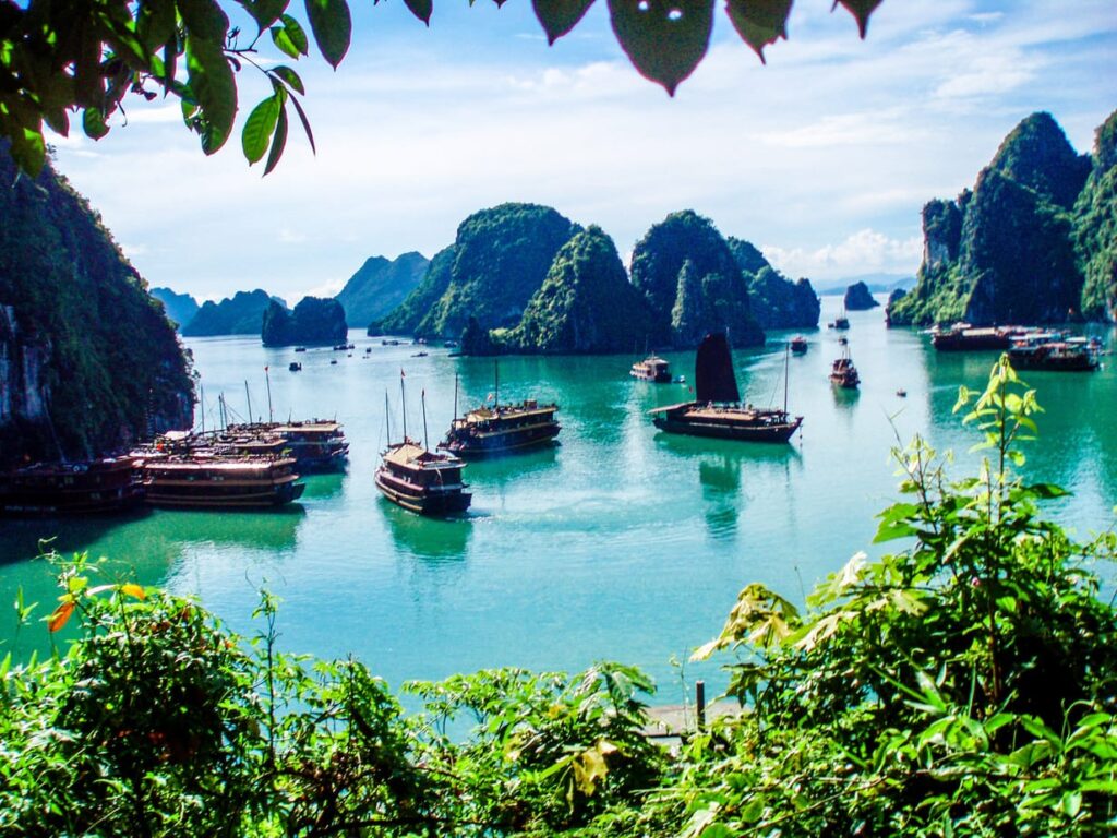 Clear summer skies over Ha Long Bay with limestone karsts rising from turquoise water, Vietnam
