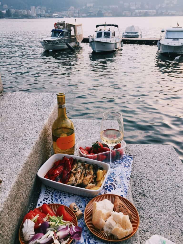Picnic at the lake with wine and snacks
