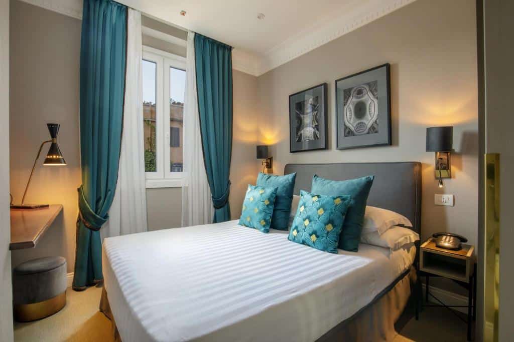 Elegant bedroom at Condotti Boutique Hotel in Rome with teal curtains, geometric artwork, and warm lighting creating a classic Italian feel.