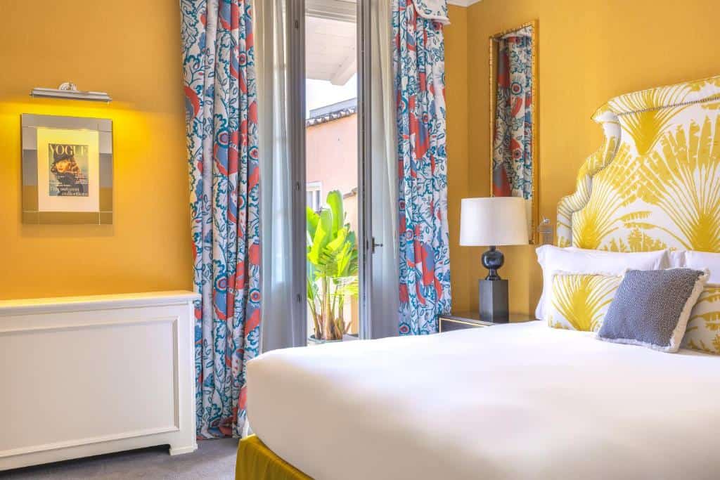 Bright, stylish room at Maalot Roma near the Trevi Fountain featuring bold yellow accents, patterned curtains, and modern Italian design.