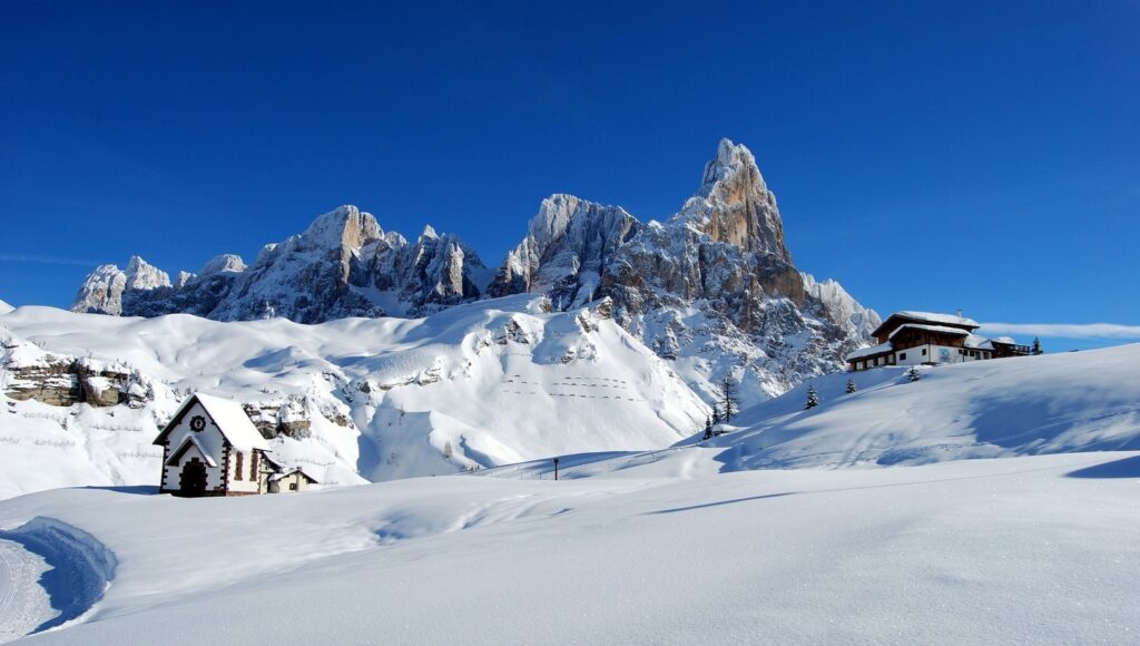 Snow-covered peaks of the Dolomites with ski slopes winding down the mountainside