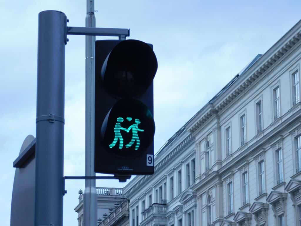 Vienna pedestrian crossing light showing a green couple holding hands with a heart above them.