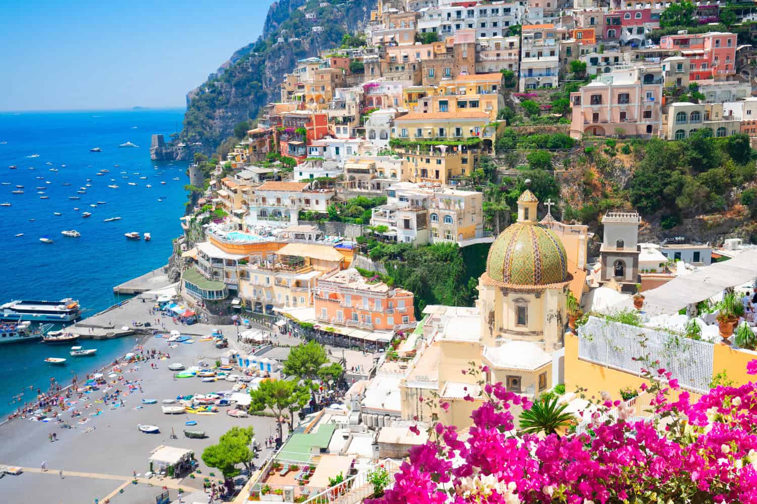 Positano town with bougainvillea flowers on a summers day