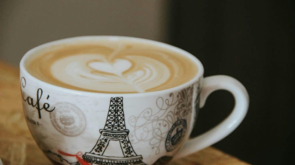 Café crème coffee in a Paris-themed cup with latte art