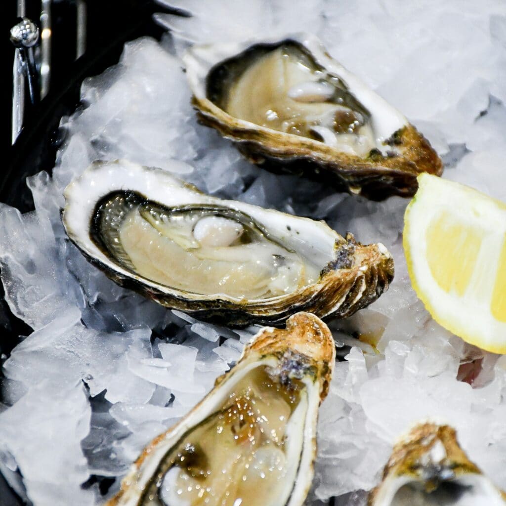 Fresh oysters on ice with lemon wedges served as a French seafood dish in Paris