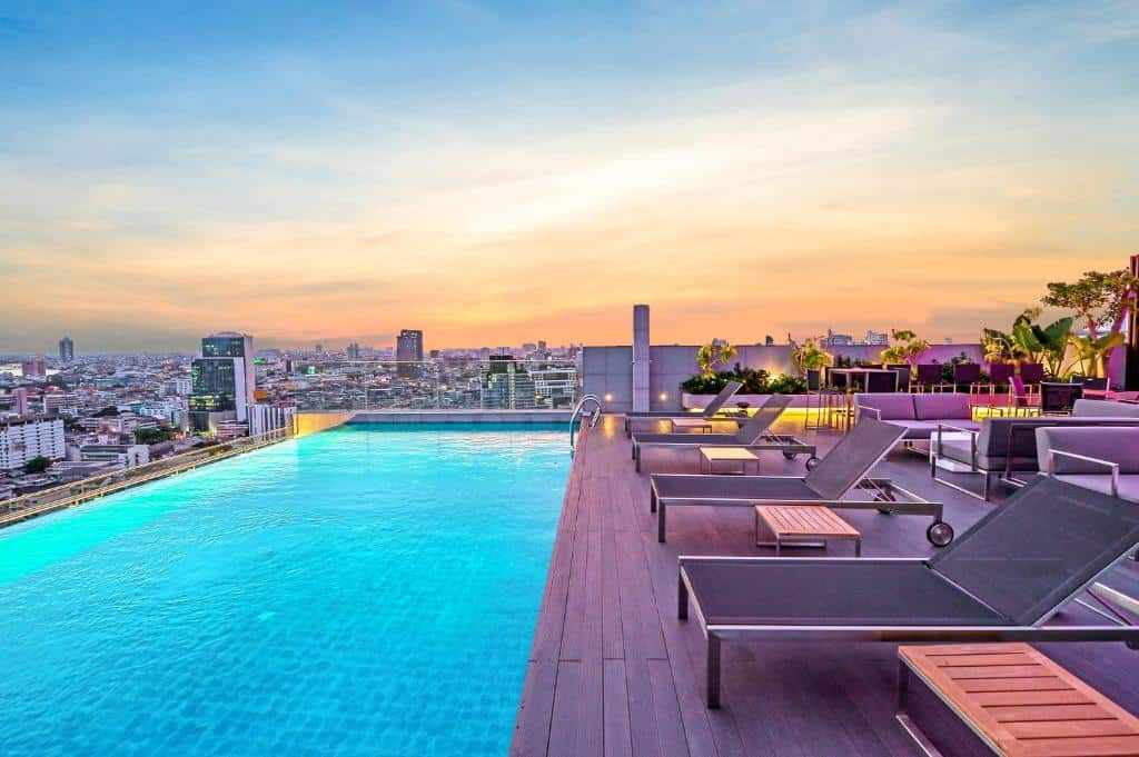 Rooftop infinity pool at Amara Bangkok overlooking the Bangkok skyline at sunset