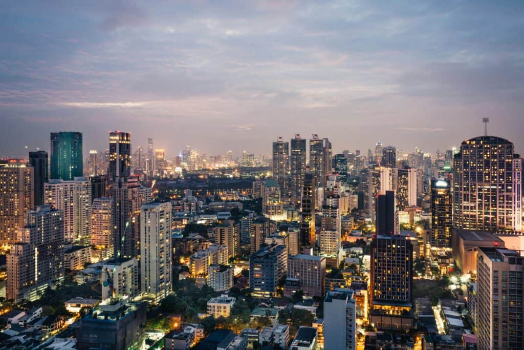Bangkok skyline at blue hour with high-rise towers and illuminated Sukhumvit streets