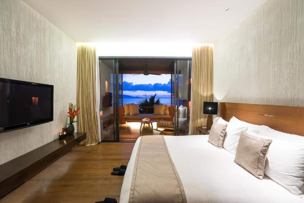 Sea-facing bedroom with oversized balcony at Hansar Samui Resort”