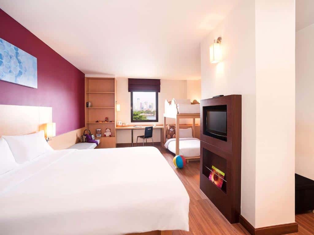 Modern bedroom at Ibis Bangkok Riverside with twin beds and bright design