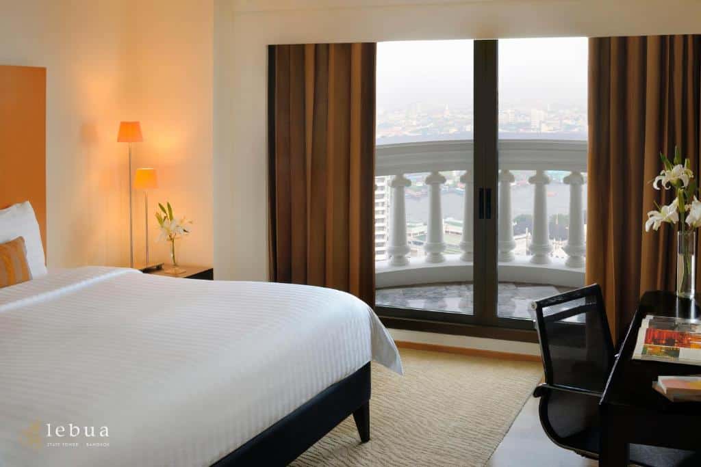 Spacious bedroom at Lebua State Tower with balcony and Bangkok skyline view