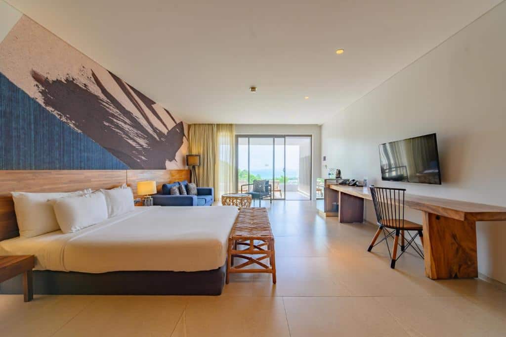 Bright hillside bedroom with sea view balcony at Mantra Samui Resort