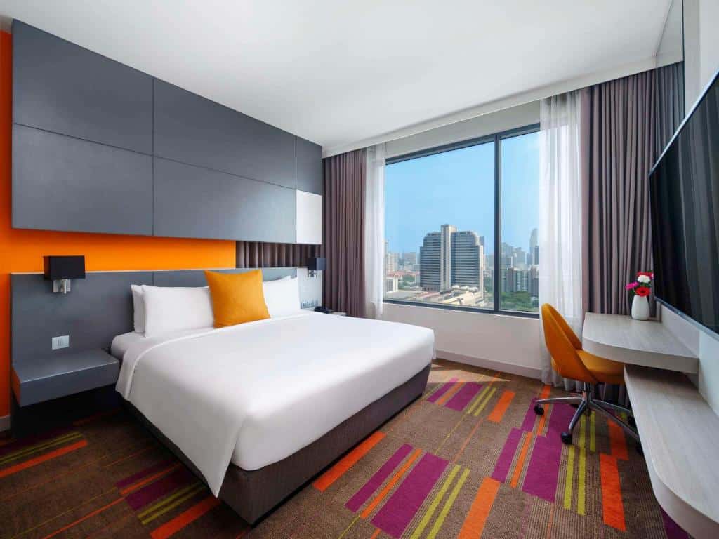 Modern hotel room at Mercure Bangkok Siam with city view window
