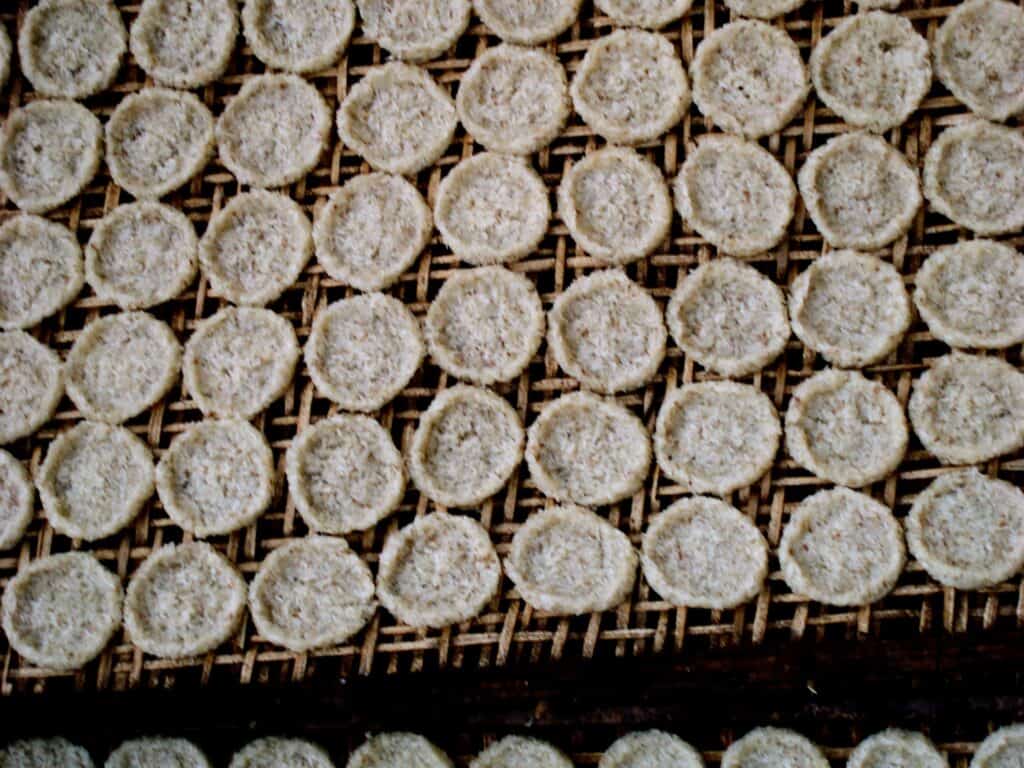 Rice cakes drying on racks