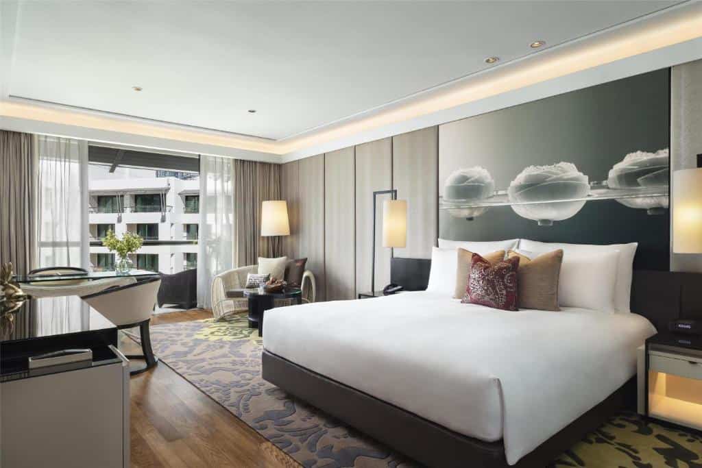 Elegant hotel room at Siam Kempinski with king bed and modern Thai deco