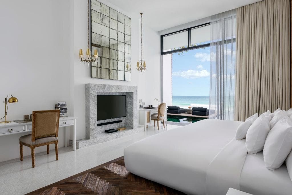 Minimalist white bedroom with bold red accents at The Library Koh Samui