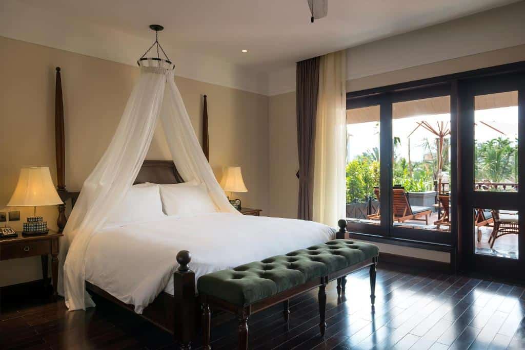 Spacious bedroom with modern Vietnamese decor and garden views at La Siesta Hoi An Resort & Spa.