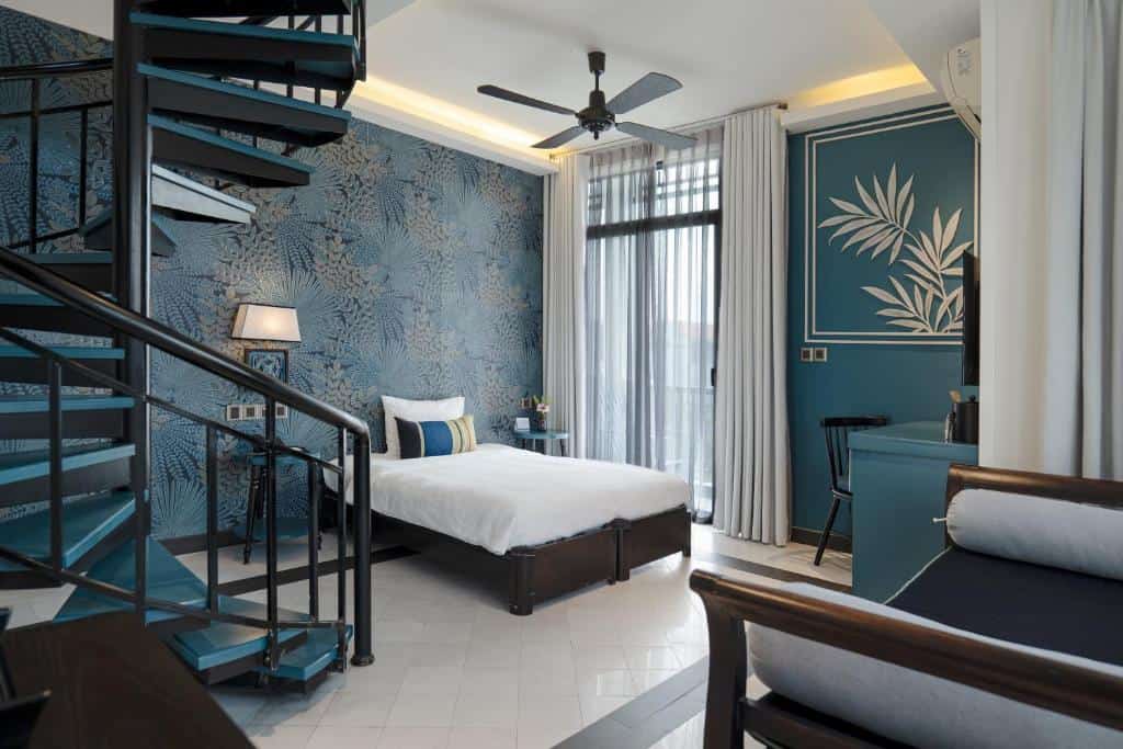 Colourful boutique hotel bedroom with modern Vietnamese design at Maison Vy Hoi An.
