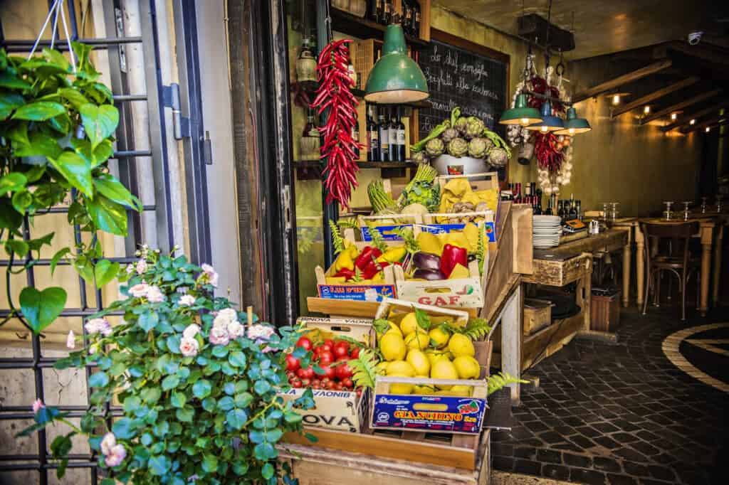 Crates of lemons, tomatoes, and peppers outside a small trattoria in Rome