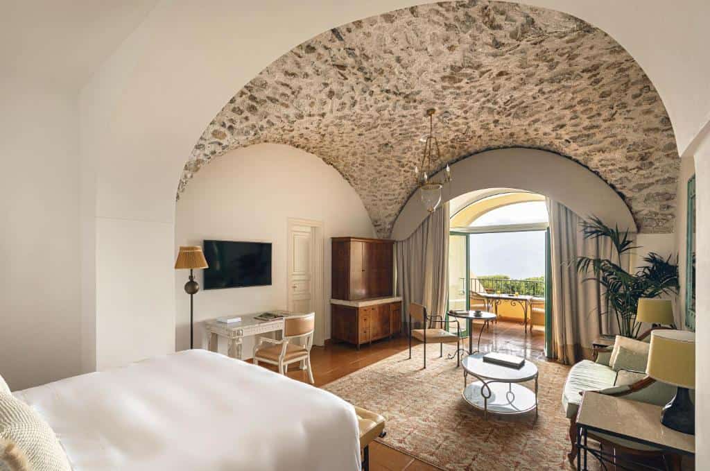 Vaulted guest room with terrace, stone ceiling, and seating area at Hotel Caruso, A Belmond Hotel, in Ravello