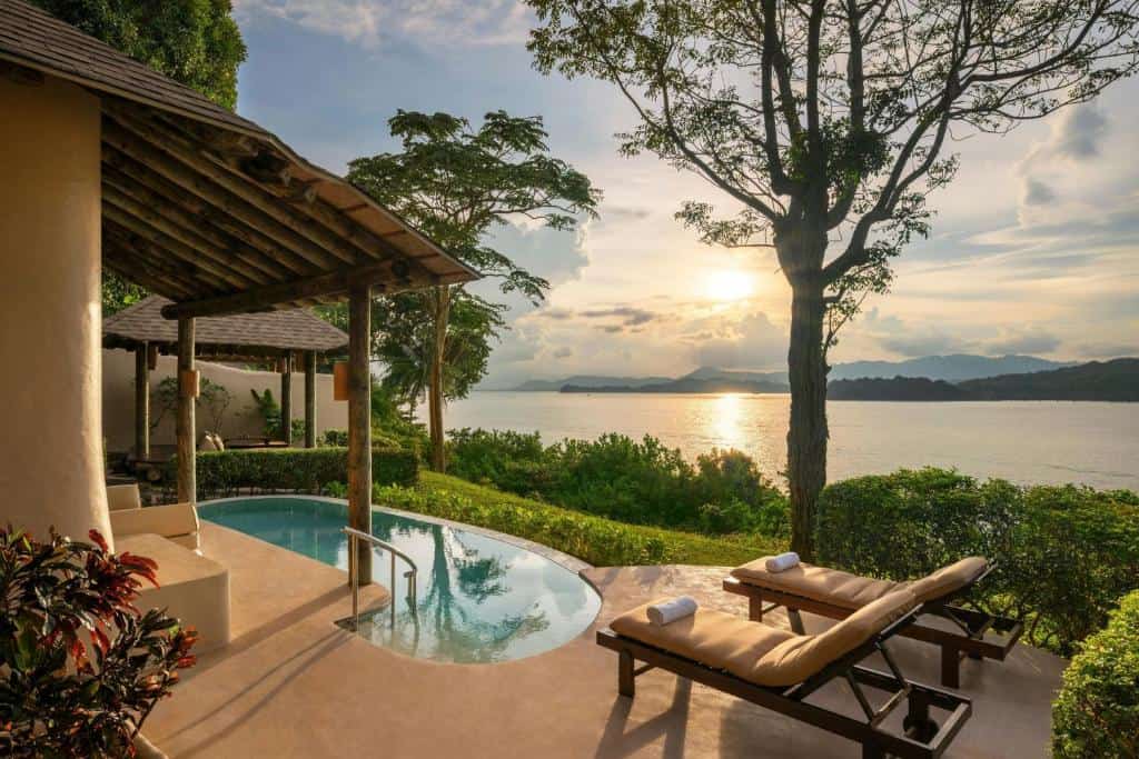 The Naka Island Phuket private pool villa overlooking Phang Nga Bay at sunset with tropical gardens and sea views