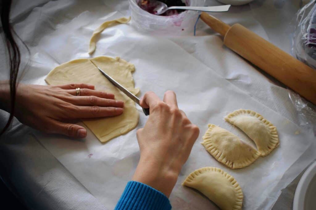 preparing traditional Hungarian dumplings during a Budapest cooking class after a market visit.